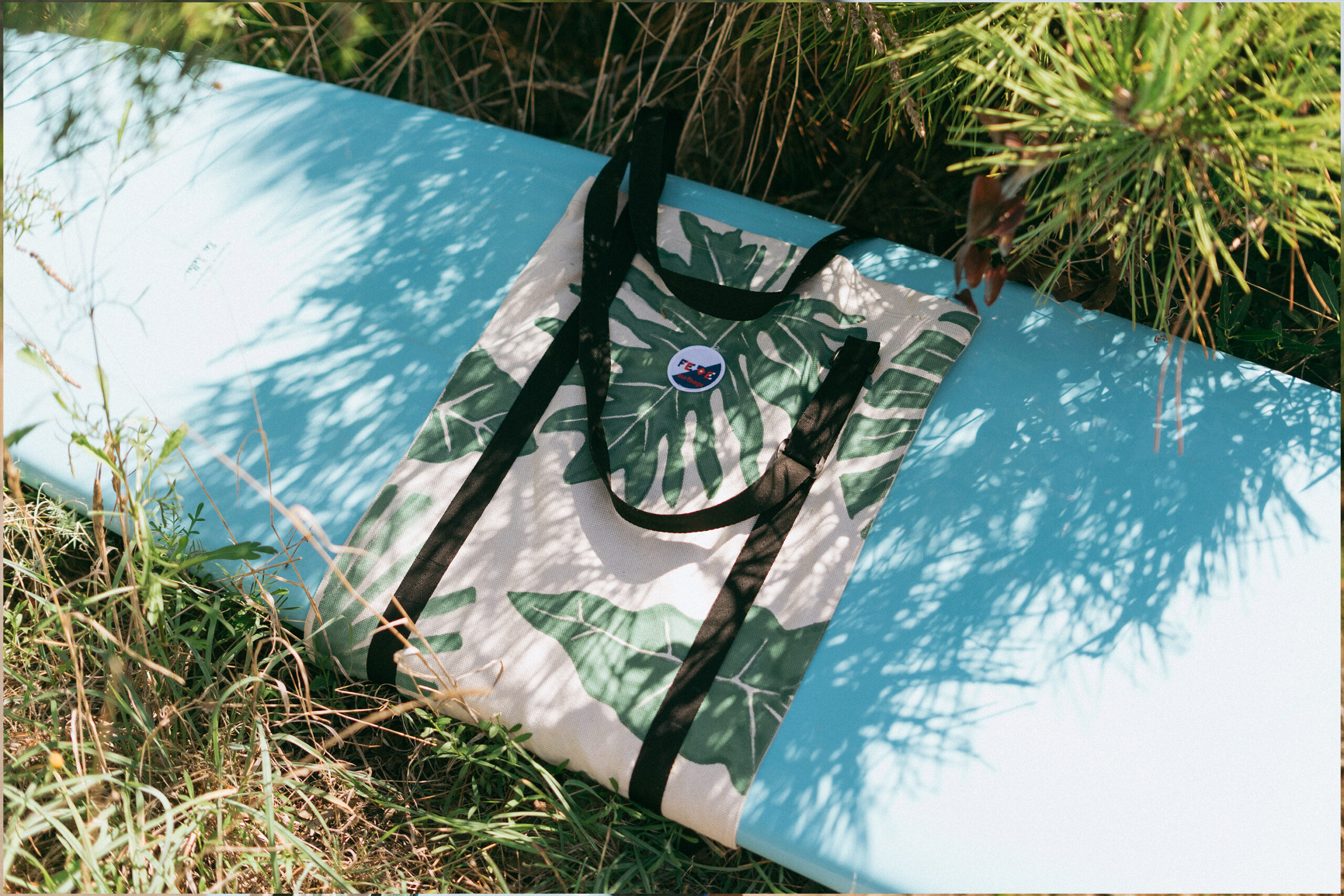 Surfboard Carrier - Surf Slin Bag to carry longboard or heavy surfboards to the beach. Made to order and hand painted with a tropical leaf design by Fede Surfbags in Italy.